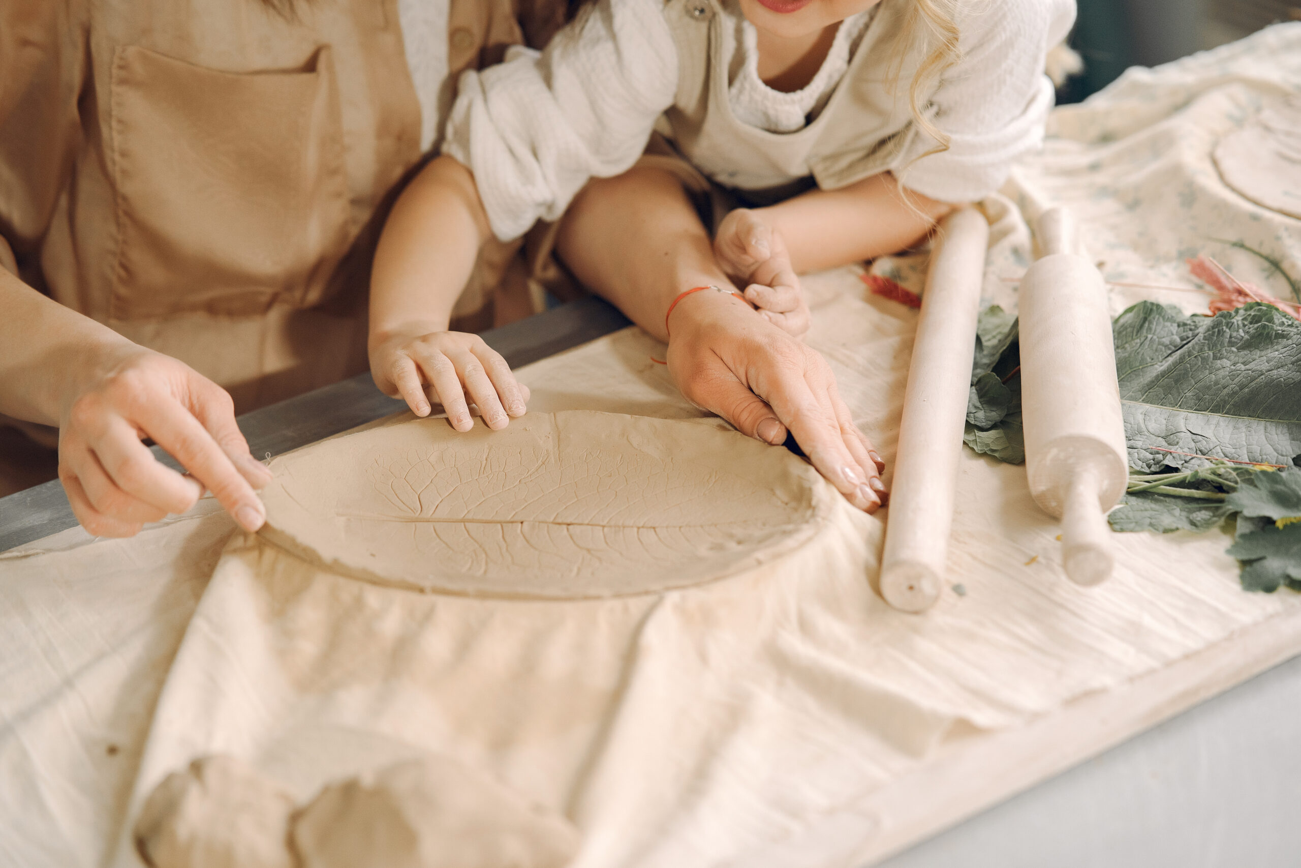 Mother and daughter working with clay at Clay Magic Pottery Studio.