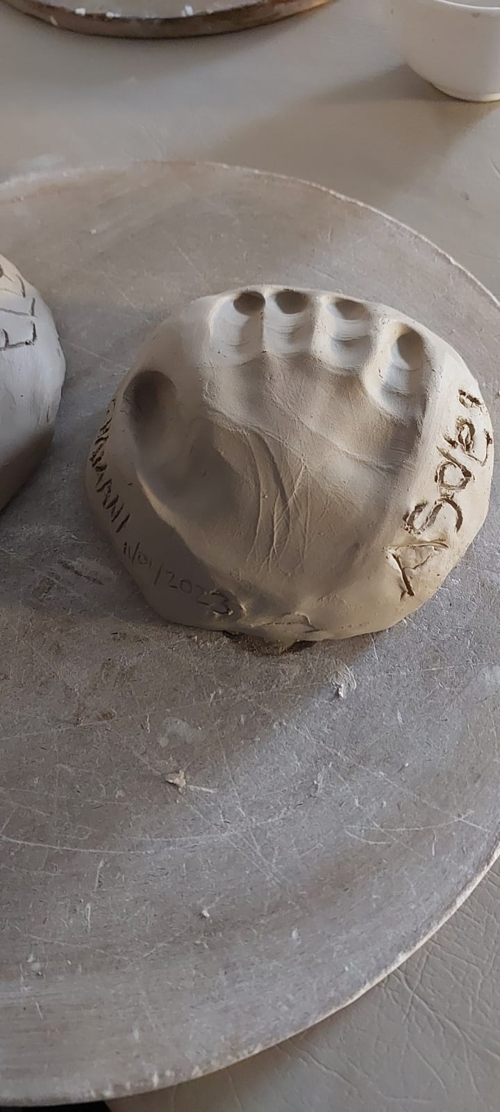 Handprint in clay by young student at Clay Magic pottery studio.