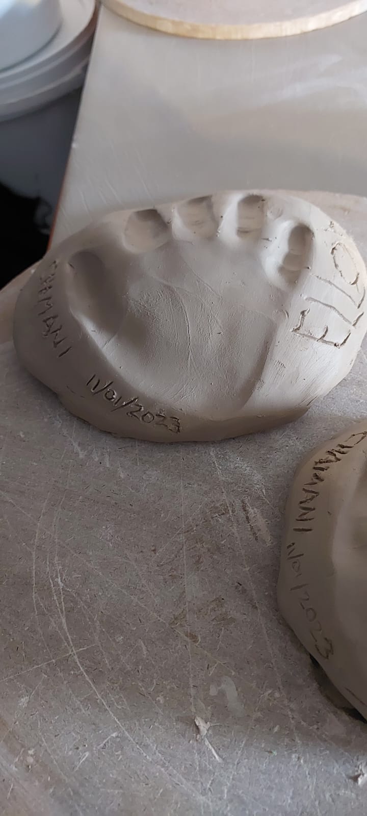 Handprint in unfired clay by young student at Clay Magic pottery studio.