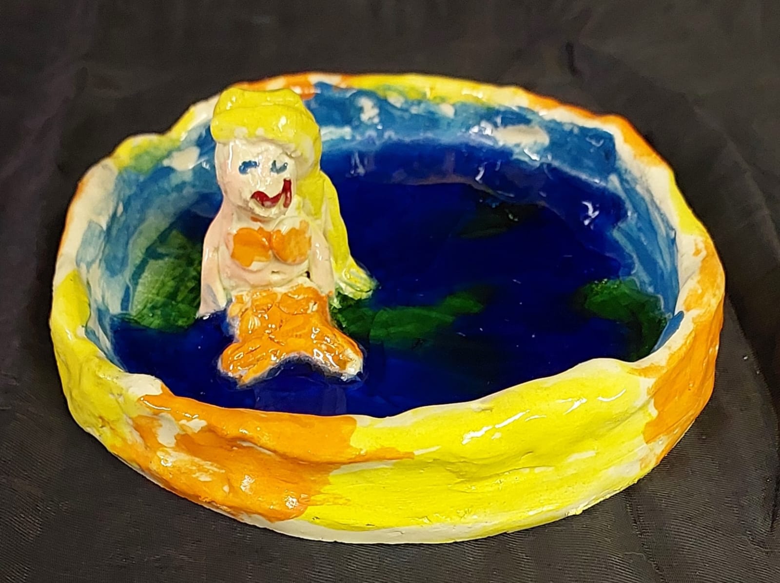 Mermaid in water sculpture made by a young student at Clay Magic pottery studio.
