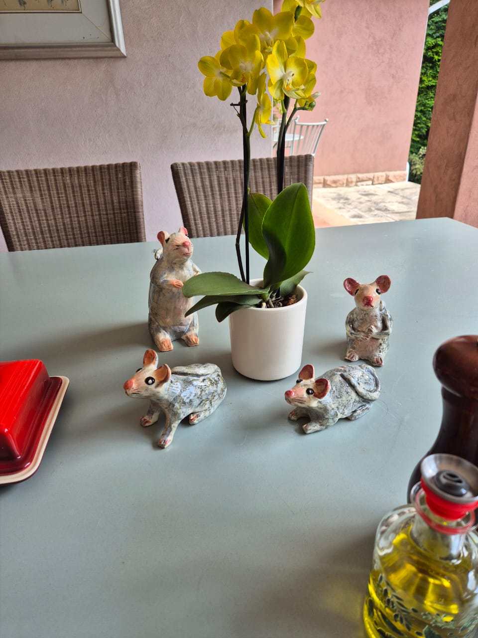 Handmade mice sculptures displayed on a outdoor table, during a pottery class