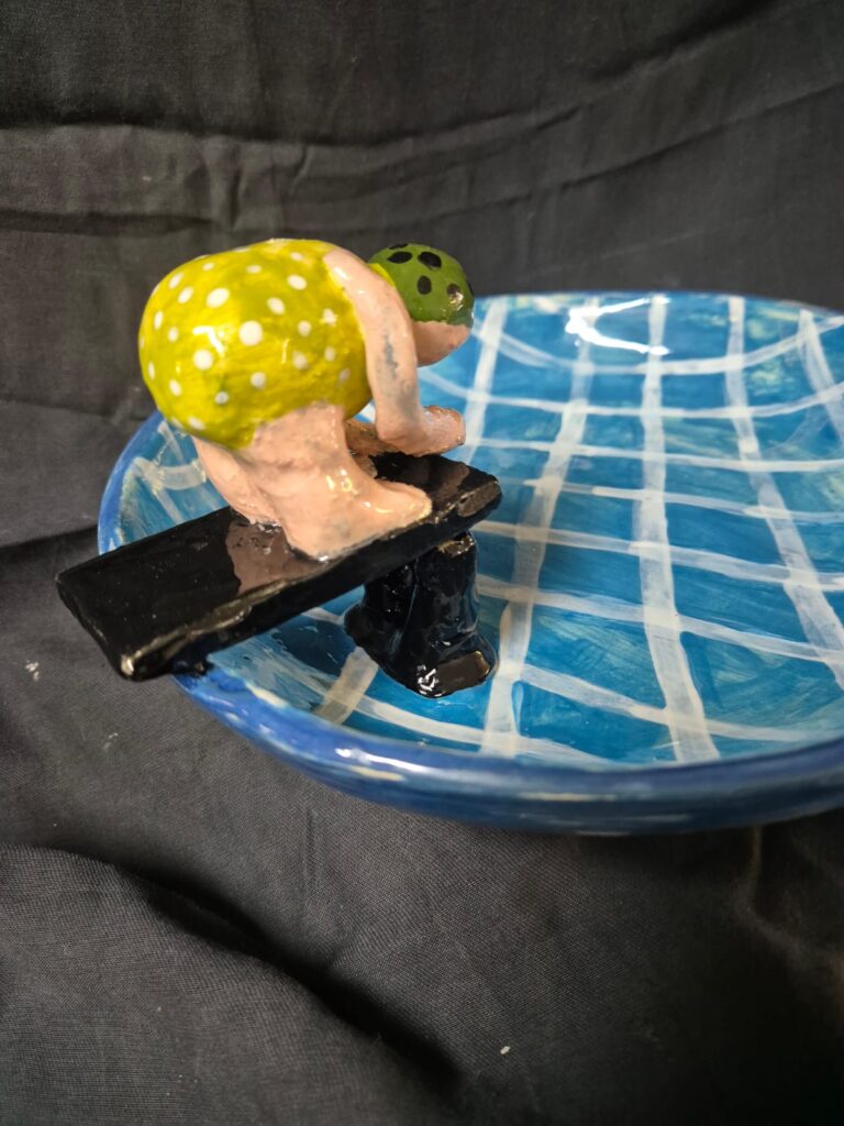 Fantasy garden bird bath sculpture featuring a swimmer and playful pool design.