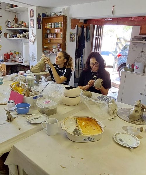 Learners working on their pottery projects together at Clay Magic pottery studio.
