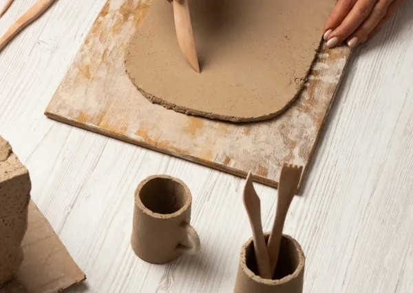 Student working with clay at Clay Magic pottery studio.