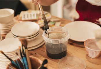 Student working with black paint Student working with black paint at Clay Magic Pottery Studio.