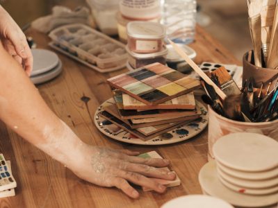 Female student working in the studio at Clay Magic Pottery Studio.