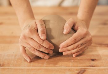 Female student wedging clay Female student wedging clay at Clay Magic Pottery Studio.